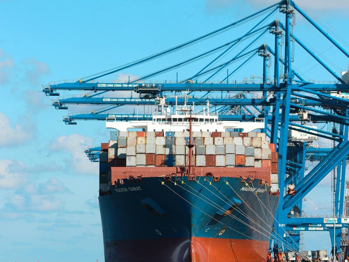 Container ship alongside the quay under gantry cranes