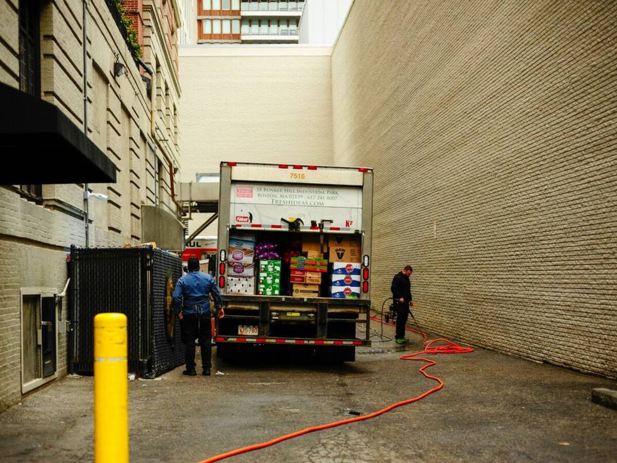 Two people unloading a delivery truck