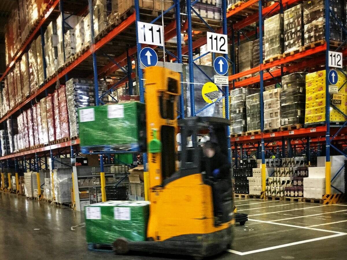 Forklift moving pallets through a warehouse